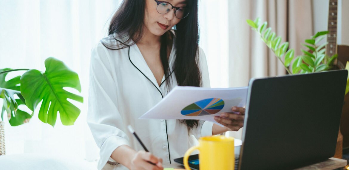 young Asian woman freelance working business work on laptop at home, working from home concept